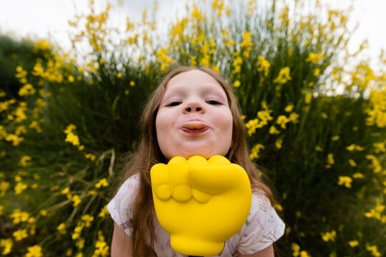 Little girl and yellow toy fist