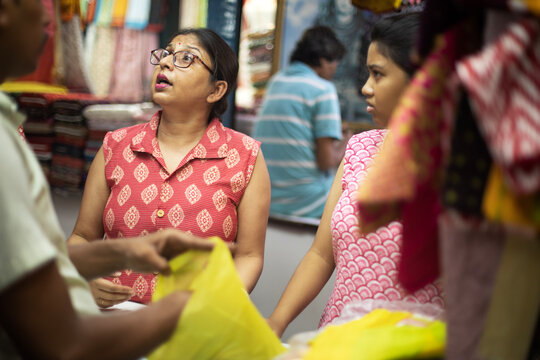 Mother and daughter buying dress material in a shop