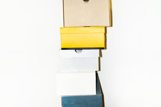 Colourful shoe boxes in towers / stacks with hard direct flashlight
