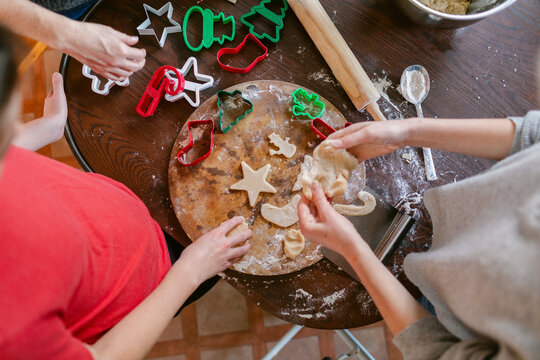 Cropped hands making Christmas cookies