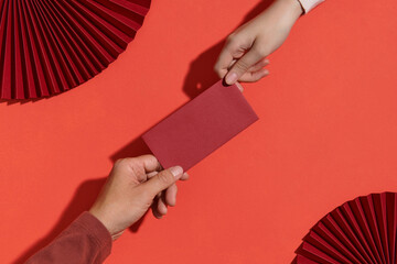 Giving red lucky envelope or Hongbao during Lunar New year