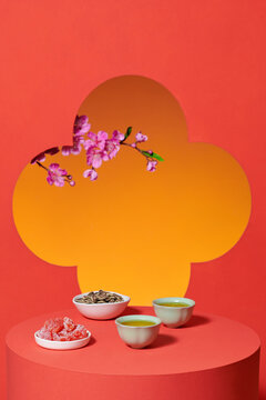 red tablecloth and green tea with seeds and tangerines served