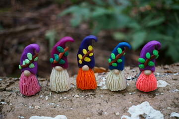 Figurines of small colorful dwarfs. Fairy-tale characters in the forest.