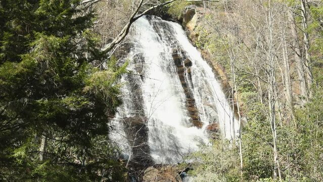 footage of the rushing water, rocks and waterfall at Anna Ruby Falls with lush green trees and plants in Helen Georgia USA