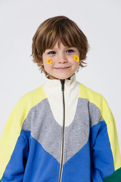 
portrait of a  boy with flowers on his face