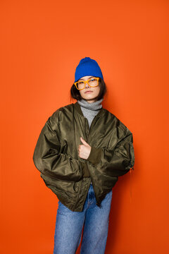 Confident young woman in bomber jacket 