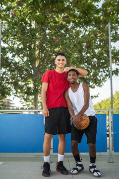Multiracial teenage female friends playing basketball in the city