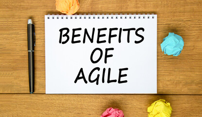 Benefits of agile symbol. Concept words Benefits of agile on beautiful white note. Beautiful wooden background. Black pen. Colored paper. Business benefits of agile concept. Copy space.