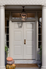 In the picturesque setting of New England, pristine white double doors stand as elegant gateways, embodying the timeless grace and refined simplicity.

