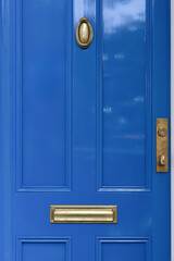 A classic blue door highlighting the elegance of urban decor in New England.
