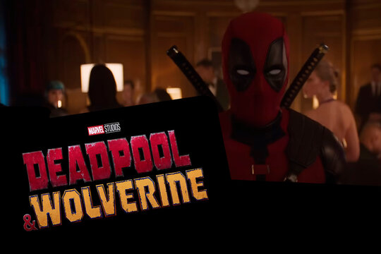 Logo of Deadpool and Wolverine movie on phone screen with movie trailer on the background on TV screen.