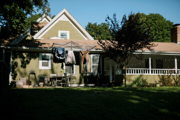 laundry hanging on drying rack in front of home