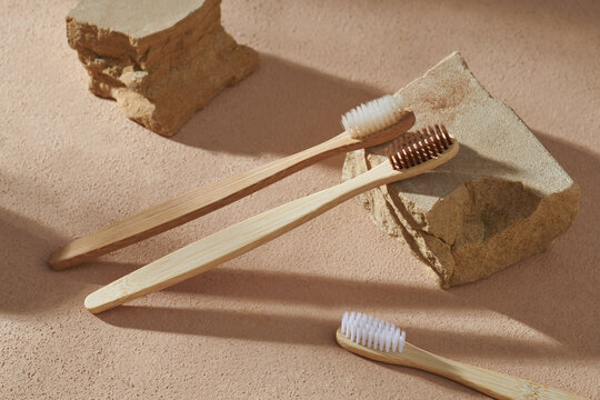 Composition of bamboo toothbrushes and rock podium blocks