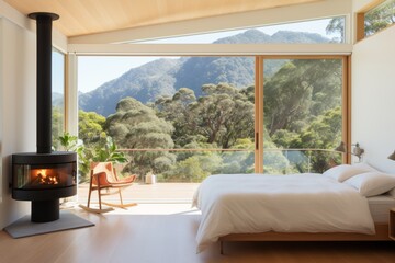 Cozy minimalistic bedroom in rays of rising sun with bed and fireplace, outside window view of green