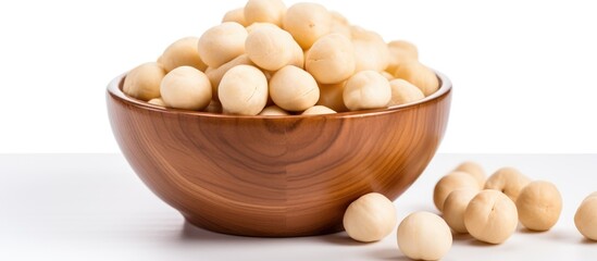 A wooden bowl filled with white beans sits atop a table, showcasing the simplicity and earthy charm of the scene.
