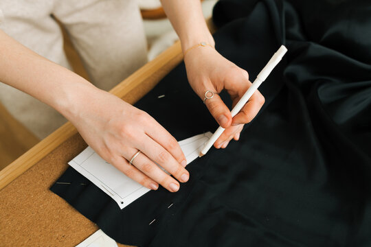 Female hands transfering pattern to fabric