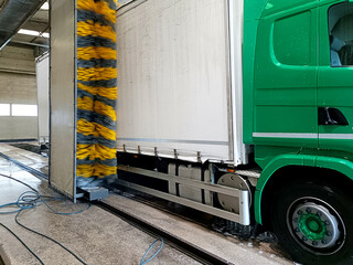 a truck being washed by brushes at a car wash