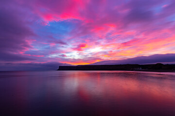 Fototapeta premium Colourful sunrise over the sea at Saltburn in the North East UK.