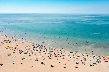Aerial view of people at the beach enjoying summer