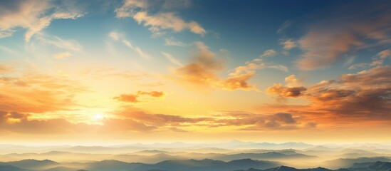 Obraz premium The sun is setting in the sky, casting a golden hue over the clouds, creating a stunning view of natures beauty.