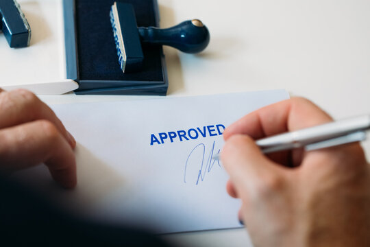 Man Signing Approved Document