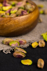 peeled pistachios in a wooden bowl, close-up