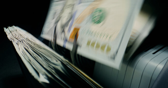 Hundred-dollar bills in the counting machine