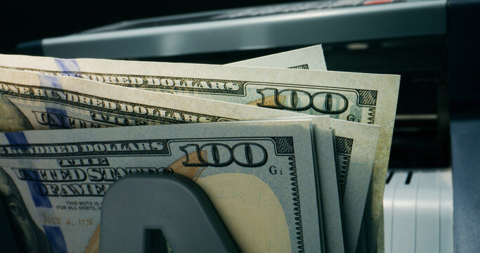 Hundred-dollar bills in the counting machine