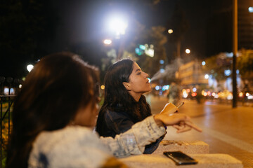 Friends Smoking in a Plaza
