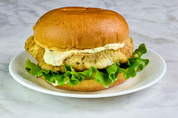 cod fillet sandwich served with l;ettuce and tarter sauce