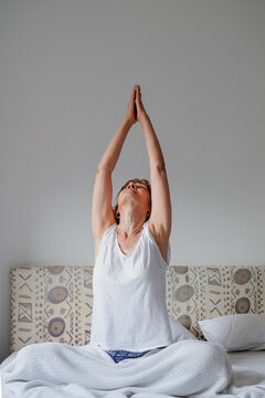Woman practicing yoga during morning time routine at home