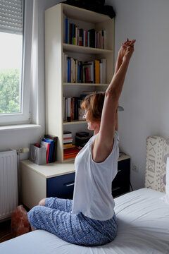 Woman practicing yoga during morning time routine at home