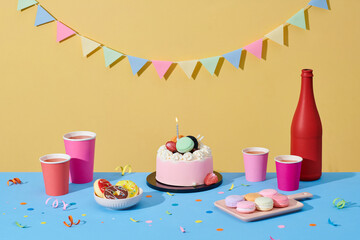 Delicious birthday cake, gifts, party hats and confetti on the table