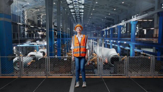 Full Body Of Asian Female Engineer With Safety Helmet Standing In Factory Manufacture Of Wind Turbines. Looking Around, Checking