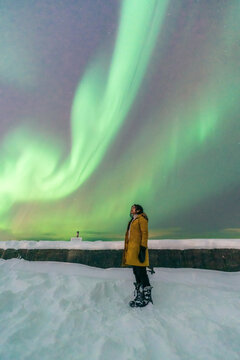 Woman looking up auroras