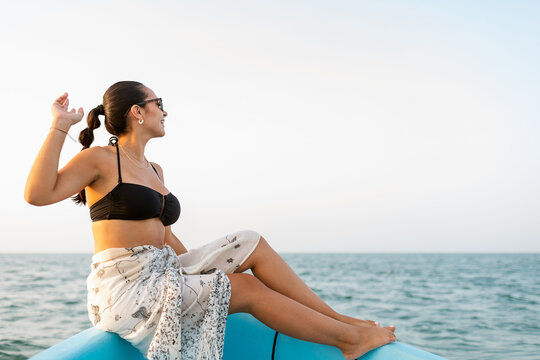 Woman Sitting at Boat's Bow