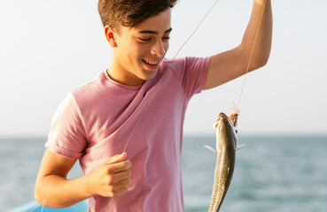 Excited Teenager Fishing on Boat
