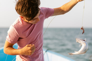 Teenager boy with Fish on Boat
