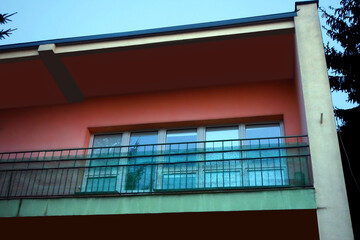 Part of the building, view of the terrace balcony - photo taken at dusk
