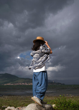 Asian girl wearing a straw hat at the Erhai Lake in Dali