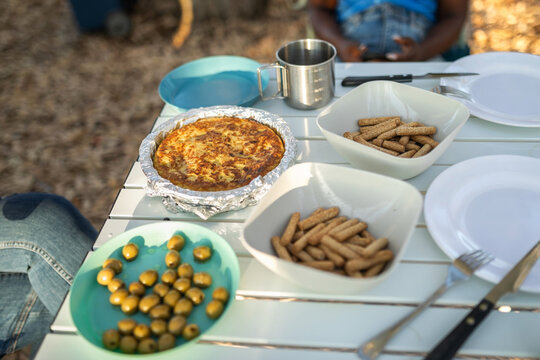 food on top of a table of two friends camping in nature