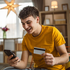 teenager young man at home use credit card shopping online