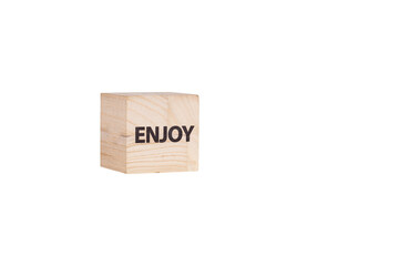 wooden cubes with the inscription Enjoy on a white isolated background close-up
