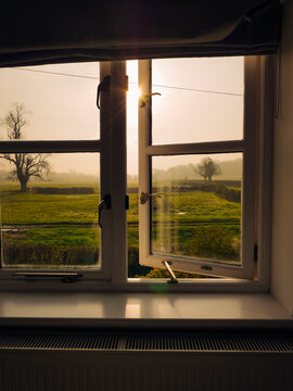 Fototapeta Sunrise from the window of a farm house