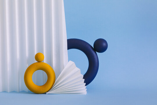 Two colored objects together on paper background