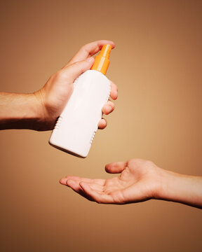 Hands holding unlabeled bottle