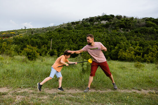 Dad and son fool around in nature
