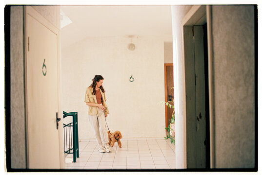 Girl with a dog getting ready for a walk