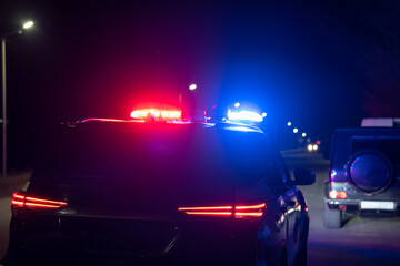 Red and blue lights of a police car at night, stock photo