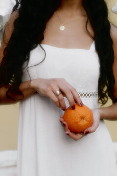 Girl eating orange in Athens Greece (color)